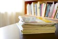 Pile of files with a bookshelf in the background