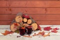 Pile of firewood, glasses of mulled wine and colorful autumn maple leaves. Selective focus. View with copy space