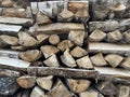 A pile of firewood is stacked. Cut down trees lie in one heap. Material for fire and heating. Birch and oak firewood, lumber Royalty Free Stock Photo