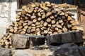 A pile of firewood in the yard of a country house. a pile of birch logs.