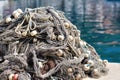 Pile of fishing nets with floats on a quay Royalty Free Stock Photo
