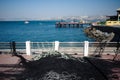 Pile of fishing nets on pier. View of jetty with fishing boats in city of Valparaiso, Chile. Yachts in bay Royalty Free Stock Photo