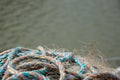 Pile of fishing rope and nylon netting. Close up view of fishing net agains sea Royalty Free Stock Photo