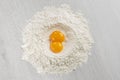 Pile of flour with egg yolks Royalty Free Stock Photo