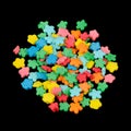 Flower-Shaped Colorful Sugar Sprinkles (Edible Cake Decorations) on Black Background