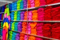 Pile of folded colourful t-shirts clothes in a shop. Royalty Free Stock Photo