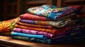 Pile folded multicolored batik clothes on a tabletop. generative ai