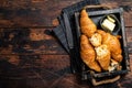 Pile Of French Buttered Croissants With Butter In Wooden Tray. Wooden Background. Top View. Copy Space