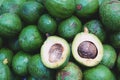 Pile of Fresh avocados and cut half tropical fruit