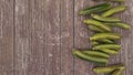 A pile of fresh cucumbers on the wooden table. Free space on the left side for your text