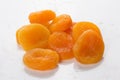 Pile of fresh dried apricots on white background, washed fruits in water , macro photo close up.