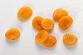 Pile of fresh dried apricots on white background, washed fruits in water , macro photo close up, top view. Royalty Free Stock Photo