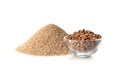 Pile of fresh flour and bowl with buckwheat Royalty Free Stock Photo