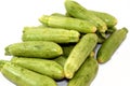 Pile of fresh green zucchini or courgette vegetables isolated on white background, selective focus of fresh raw organic squash Royalty Free Stock Photo