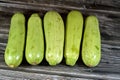 Pile of fresh green zucchini or courgette vegetables  on wooden background, selective focus of fresh raw organic squash Royalty Free Stock Photo