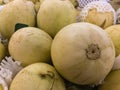 Pile of fresh melon for sale in the supermarket. organic fresh melon in foam covered in fruit market Royalty Free Stock Photo