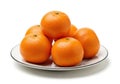 A pile of fresh oranges on a white plate isolated on white background Royalty Free Stock Photo