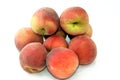 pile of fresh peach fruit isolated on white background, selective focus of a stack of ripe bright peaches, healthy fresh food