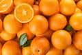 Pile of fresh ripe oranges with leaves as background Royalty Free Stock Photo