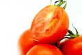 Pile of fresh ripe organic tomato in burlap sack on rotating plate isolated on white background