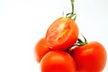 Pile of fresh ripe organic tomato in burlap sack on rotating plate isolated on white background