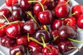 Pile of fresh ripe red cherry berries on white plate topview. Organic local food Royalty Free Stock Photo