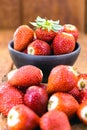 Pile of fresh strawberries with spot focus on isolated wooden background Royalty Free Stock Photo