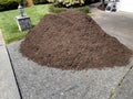 Pile of fresh topsoil in home driveway for lawn maintenance Royalty Free Stock Photo