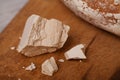 A pile of fresh yeast with a Homemade bread on old cutting board