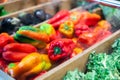 Pile of freshly harvested ripe colorful peppers on market counter