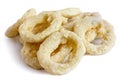 Pile of frozen uncooked battered onion or calamari rings isolate