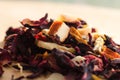 Pile of fruit tea with petals and dry fruit .The composition of the heap of tea leaves and dried hibiscus flower located on a wood Royalty Free Stock Photo