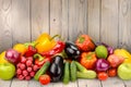 Pile fruits and vegetables on wooden table on background wooden