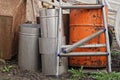 A pile of garbage from a broken gray metal stepladder with a red barrel and pieces of iron