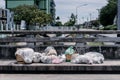 A pile of garbage are dropped on the footpath over the canal bridge in the midday time