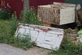 A pile of garbage from old white wooden doors and gray boxes stand on the ground Royalty Free Stock Photo
