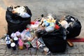 Pile of Garbage plastic black and trash bag waste many on the footpath, pollution trash, Plastic Waste and Bag Foam tray Garbage Royalty Free Stock Photo