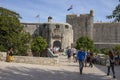 Tourists walk in front of the main entrance of the Old Town gate. Dubrovnik, Croatia Royalty Free Stock Photo