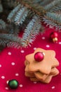 A pile of gingerbread Christmas cookies on red polka dot towel