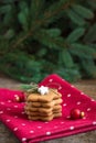 A pile of gingerbread Christmas cookies on red polka dot towel