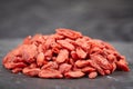 Pile of goji berries on a black stone plate Royalty Free Stock Photo