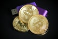 Pile of gold bitcoin cryptocurrency coins with purple digital ha