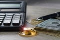 A pile of gold coins, dollar bills, gold credit card, pen and a calculator Royalty Free Stock Photo