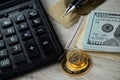 Pile of a gold coins, dollar bills, gold credit card, pen and a calculator Royalty Free Stock Photo