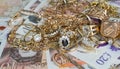 Pile of gold and English pounds UK Money Royalty Free Stock Photo