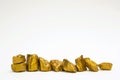 A pile of gold nuggets or gold ore on white background, precious Royalty Free Stock Photo