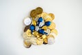 Pile of gold and silver Hanukkah coins with tiny dreidels isolated on white Royalty Free Stock Photo