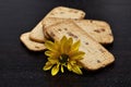 A pile of golden brown biscuits with a yellow flower