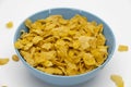 Pile of Golden cornflakes in the blue bowl ready for adding fresh milk for breakfast Royalty Free Stock Photo