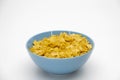 Pile of Golden cornflakes in the blue bowl ready for adding fresh milk for breakfast Royalty Free Stock Photo